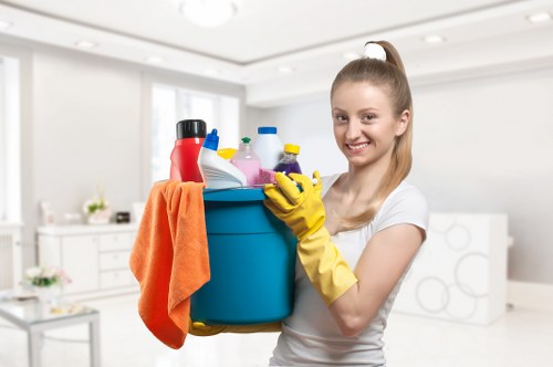 Technician treating stains on a lounge suite during upholstery cleaning